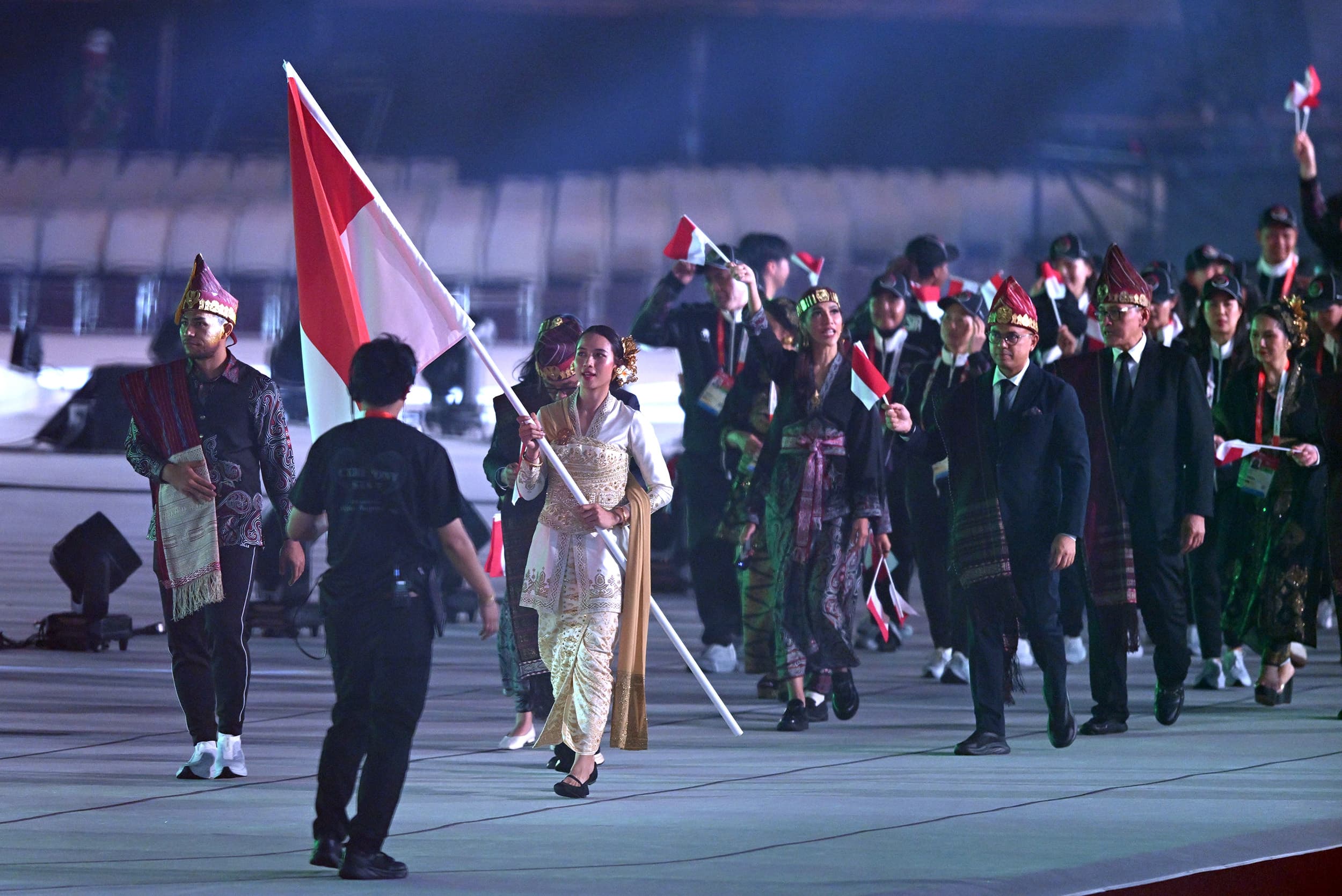 Pebasket Dewa Ayu Made Sriartha Kusuma Dewi (kedua kiri) didampingi karateka Daniel Hutapea (kiri) membawa bendera Merah Putih saat defile Kontingen Indonesia dalam Asian Games 2026 di Stadion Paloma Mizuho, Nagoya, Aichi, Jepang, Sabtu (19/9/2026).ANTARA FOTO/Fauzan/sgd